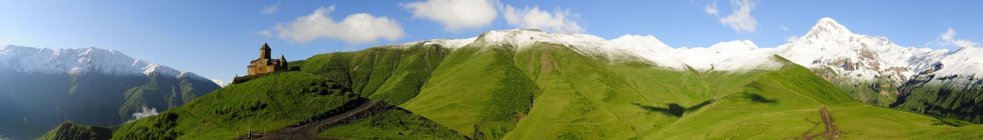 360-degree panoramic view of the Gergeti Trinity Church, the Mount Kazbek, and Mount Shani in Georgia